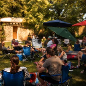 Guests relaxing in the sunlit garden during a daytime private event at Bandpitt Barn in Somerset